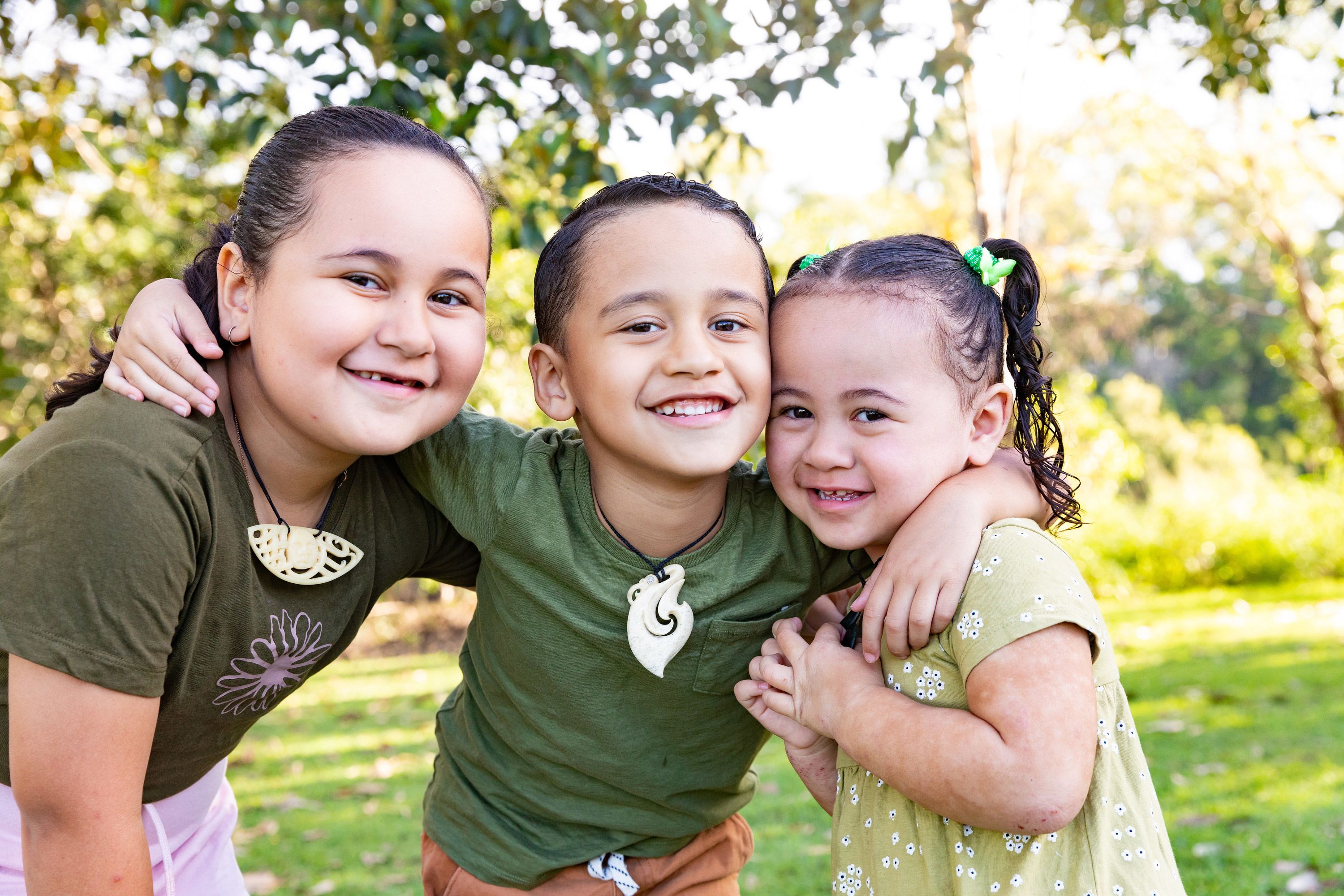 A group of people walking down a road at sunset